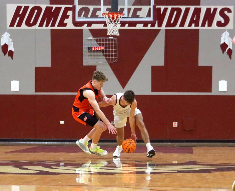 Richmond-Burton’s Dane Gardner, right, tussles with Crystal Lake Central’s JR Mason in varsity boys basketball E.C. Nichols tournament championship game action on Saturday, Dec. 27, 2025, at Homer “Bill” Barry Gymnasium on the campus of Marengo High School in Marengo.