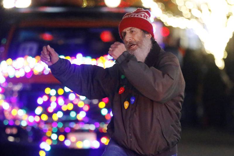 Paul Escallier of Ozinga dances to the music during the annual Festival of Lights Parade on Friday, Nov. 26, 2021, in downtown Crystal Lake.