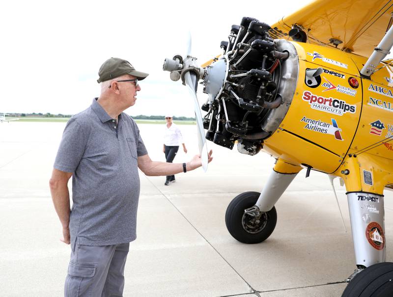 Ed Lenertz, a resident of Covenant Living at the Holmstad in Batavia, gets a close look at a 1942 open cockpit Boeing Stearman, the same airplane used to train military aviators in the 1940s during a Dream Flight at the DuPage Airport in West Chicago on Saturday, July 29, 2023. The flights were courtesy of Ageless Aviation Dreams Foundation, a non-profit organization to honor U.S. military veterans living in long-term care facilities.