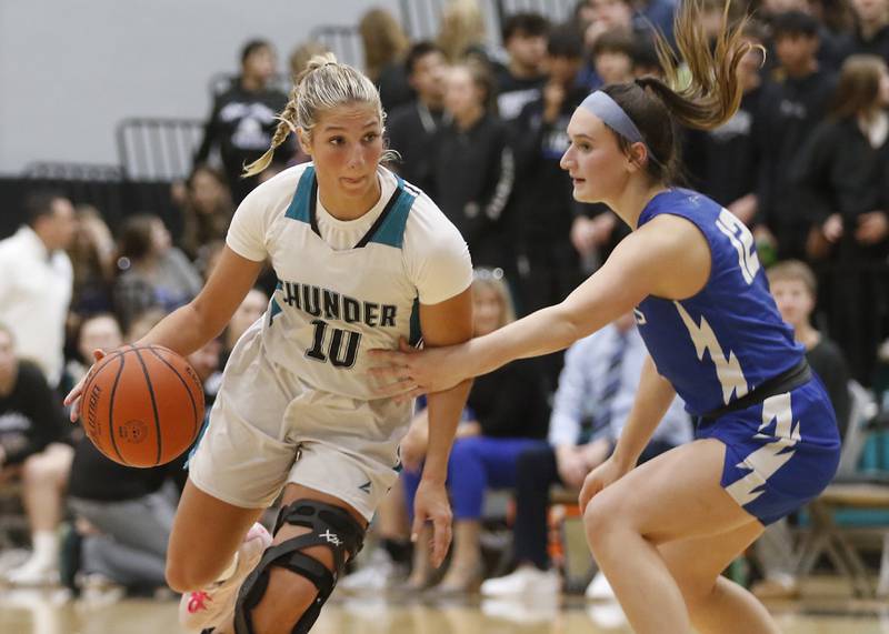 Woodstock North’s Addison Rishling drives to the basket against Woodstock's Savannah Griffin during a Kishwaukee River Conference girls basketball game on Friday, Jan. 5. 2024, at Woodstock North High School.