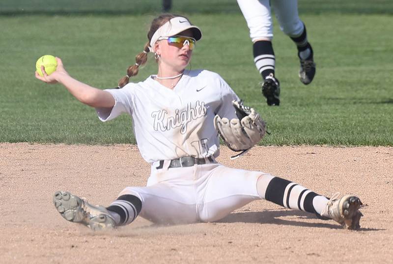 Kaneland's Katie Congoran is able to throw out a Sycamore runner after falling down making a play Friday, April 28, 2023, during their game at Sycamore High School.