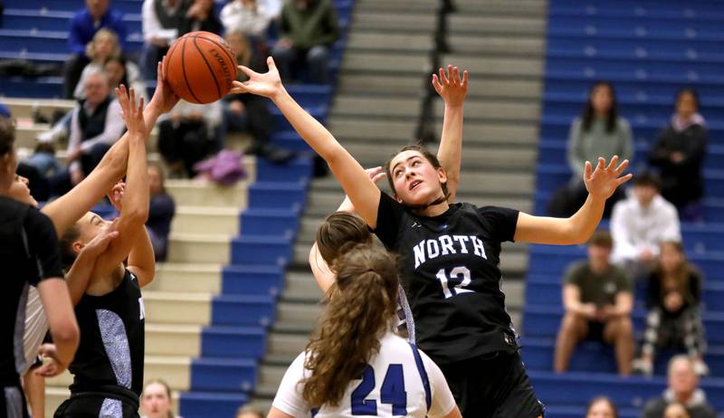 St. Charles North’s Riley Barber reaches for the rebound during a game at Geneva on Tuesday, Feb. 6, 2024.