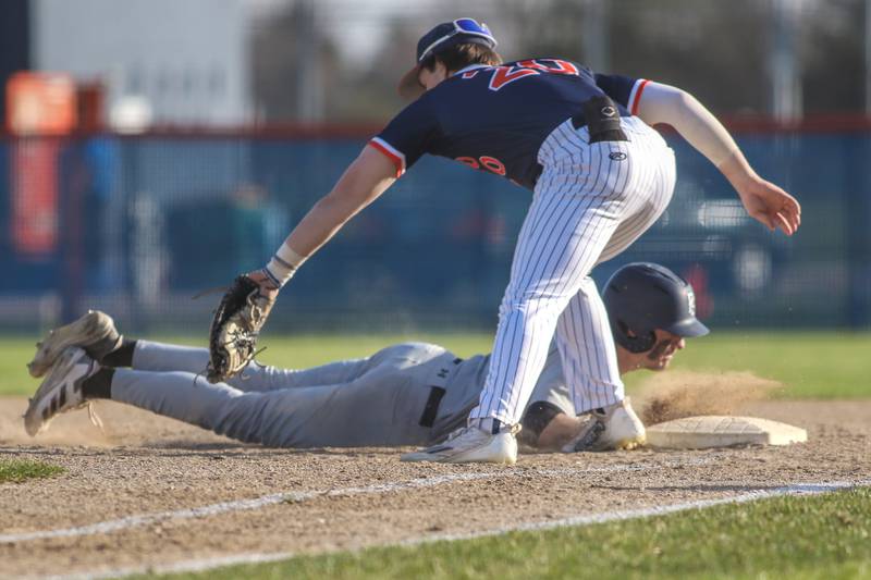 Plainfield South's Caden Pierceall (3) dives back to first during a pickoff attempt during baseball game between Plainfield South at Oswego on Monday, April 14, 2025 in Oswego.