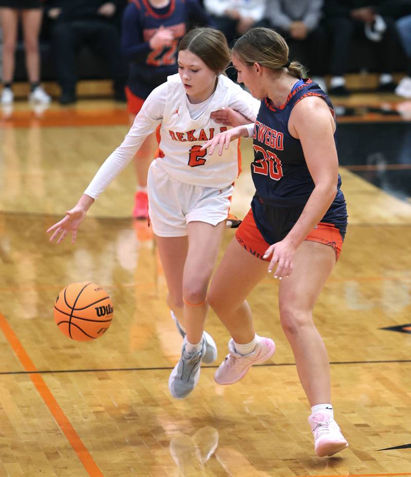 DeKalb's Emma Craig pushes the ball upcourt against Oswego's Peyton Johnson during their game Monday, Jan. 5, 2026, at DeKalb High School.