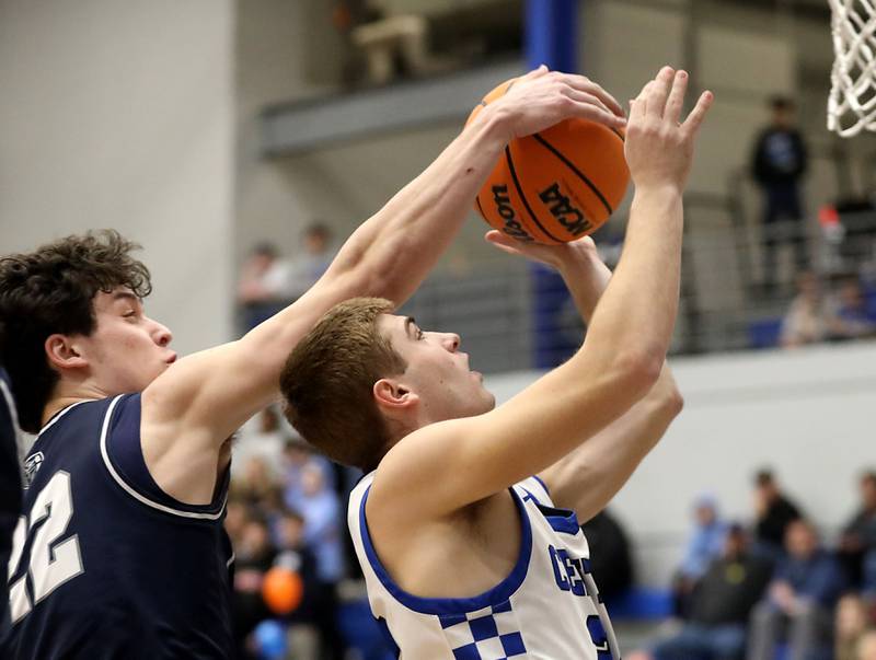 Cary-Grove's Adam Bauer blocks the shot of Burlington Central's Bennek Braden during a Fox Valley Conference boys basketball game on Friday, February. 6, 2026, at Burlington Central High School.
