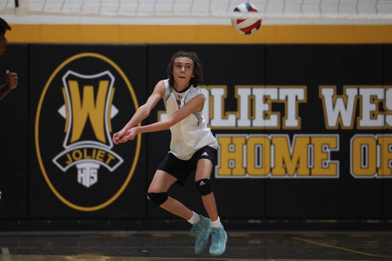 Joliet West’s  Jorge Morales receives a serve against Providence on Thursday, March 23, 2023 in Joliet.