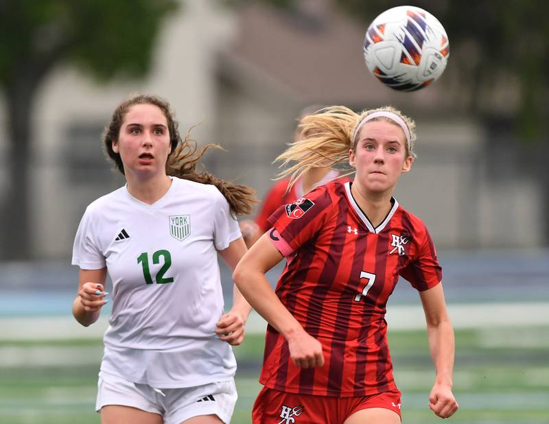 York’s Ellie Kehoe (12) and Hinsdale Central’s Avery Edgewater race for a bouncing ball during the Class 3A Downers Grove South Sectional final game on May 30, 2025 at Downers Grove South High School in Downers Grove .