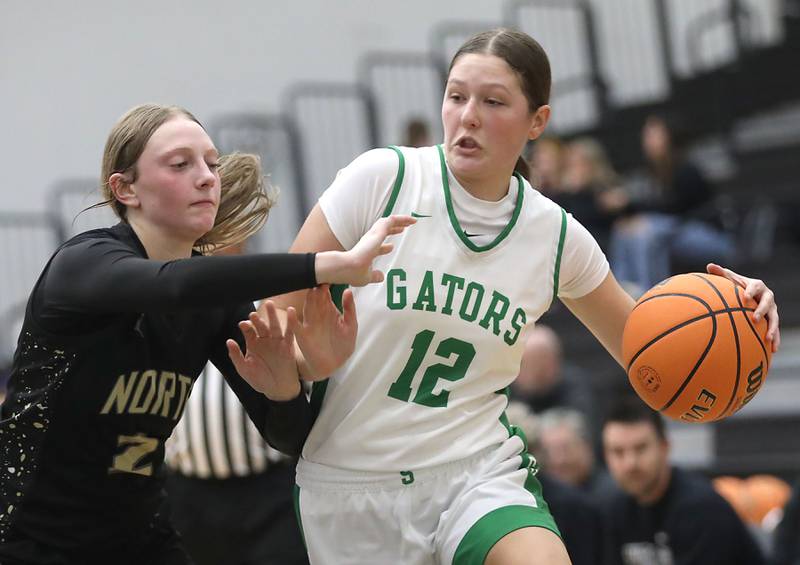 Crystal Lake South's Gaby Dzik drives against Grayslake North's Ashlyn Stoneham during a Northern Illinois Holiday Classic semifinal girl basketball game on Tuesday, Dec. 16, 2025, at McHenry High School.