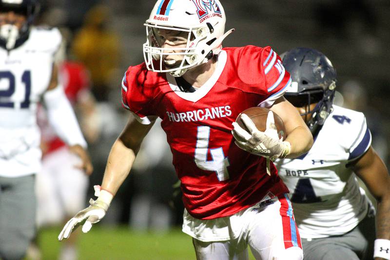 Marian Central’s Quinn Brady runs the ball against Chicago Hope in varsity  football at Woodstock Friday night.