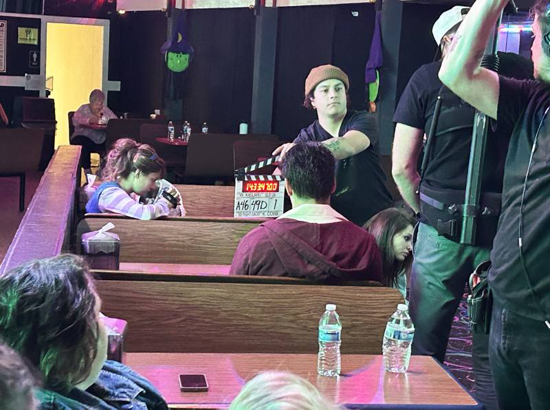 A crew member of the movie "Be Right Back" holds the clapperboard marking the start of a scene being shot at The Rink at Pine Creek on Monday, Oct. 21, 2024. The Rink, located on Pines Road, one-quarter mile west of the entrance to White Pines State Park, was one of the local sites where scenes were filmed. A clapperboard is used to mark the start of a scene and tells the post-production team when recording has started and stopped.