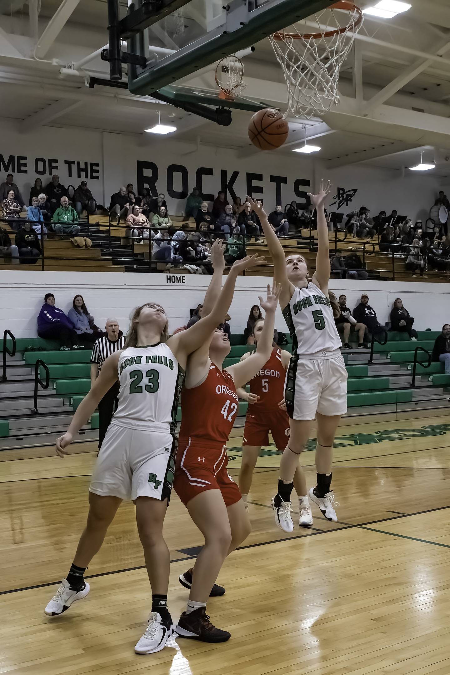 Rock Falls' Claire Bickett (23) and Rylee Johnson (5) go up for a rebound against Oregon's Teagan Champley (42) during their Big Northern Conference game Friday night at Tabor Gym.