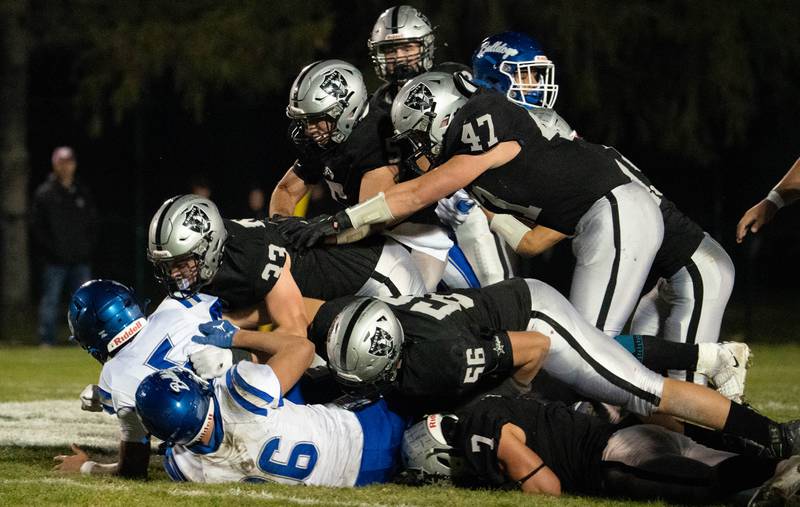Kaneland’s Josh Mauthe (33) leads a group of defenders on a sack of Riverside Brookfield's Diego Gutierrez (5) during a 6A playoff football game at Kaneland High School in Maple Park on Friday, Oct 28, 2022.