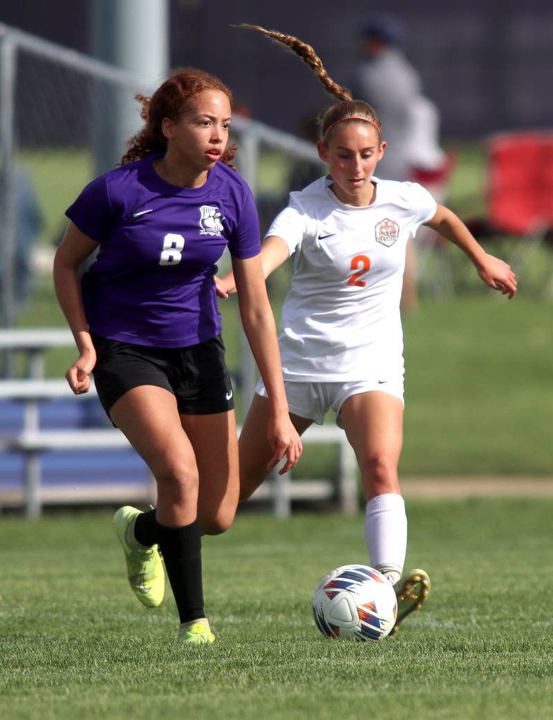 Hampshire’s Mikala Amegasse, left, and Crystal Lake Central’s Kalissa Kaiser race for the ball  in varsity soccer at Hampshire Tuesday evening.