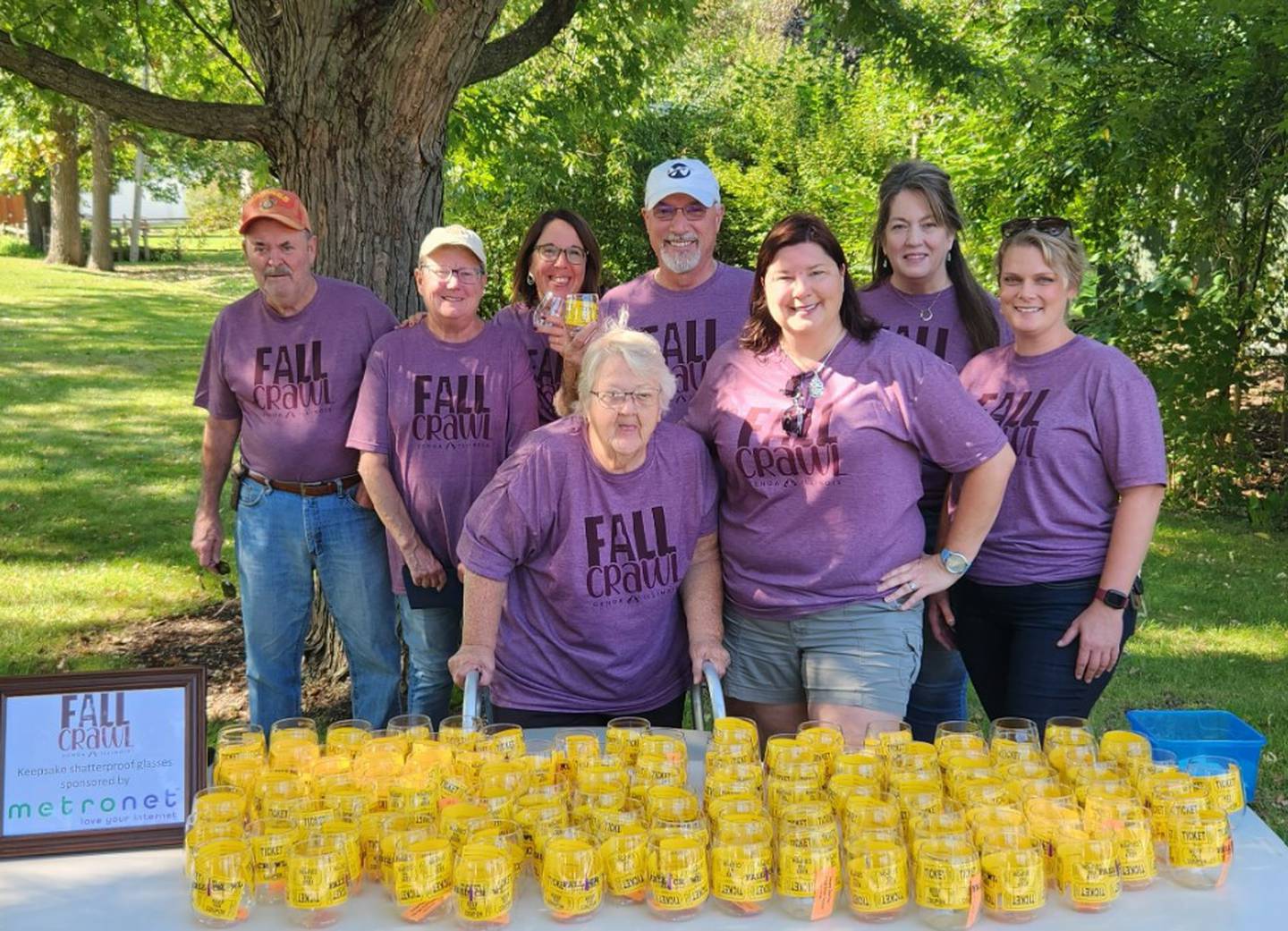 Organizers and Genoa Area Chamber of Commerce staff set up at the October 2023 Fall Crawl booth in Genoa where participants received their drinking glass.