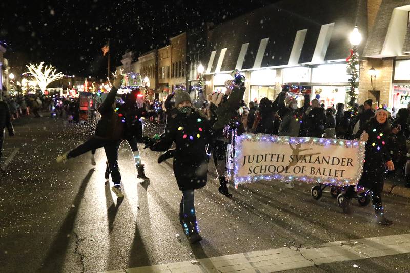 Members of the Judith Svalander School of Ballet entertain as they pass by during the annual Festival of Lights Parade on Friday, Nov. 26, 2021, in downtown Crystal Lake.