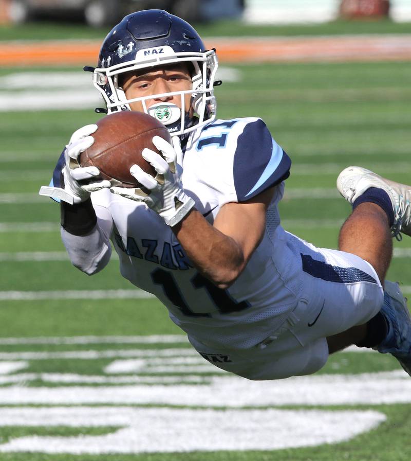 Nazareth's James Penley makes a diving catch behind the Peoria defense during their IHSA Class 5A state championship game Saturday, Nov. 26, 2022, in Memorial Stadium at the University of Illinois in Champaign.