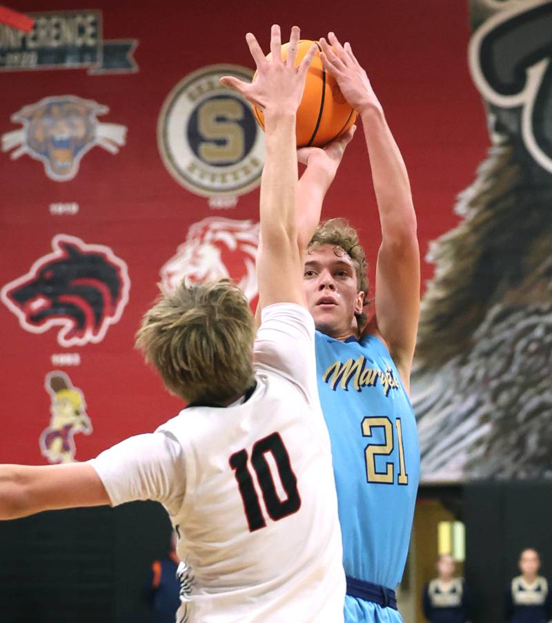 Marquette’s Lucas Craig shoots over Indian Creek's Parker Murry Monday, Dec. 9, 2025, during their game at Indian Creek High School in Shabbona.