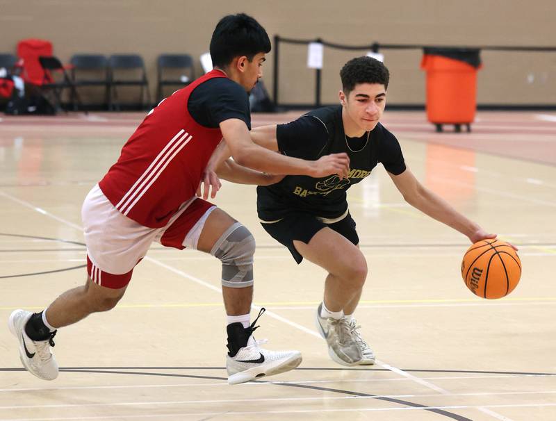 Sycamore’s Marcus Johnson drives by a defender Friday, June 20, 2025, during their game against Marmion in the DeKalb Live summer tournament at DeKalb High School.