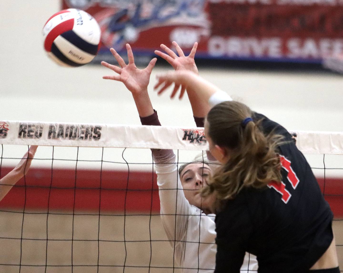 Prairie Ridge’s Maizy Agnello, left, blocks Huntley’s Lucy Watson in varsity girls volleyball at Huntley High School in Huntley on Thursday, Sept. 11, 2025.