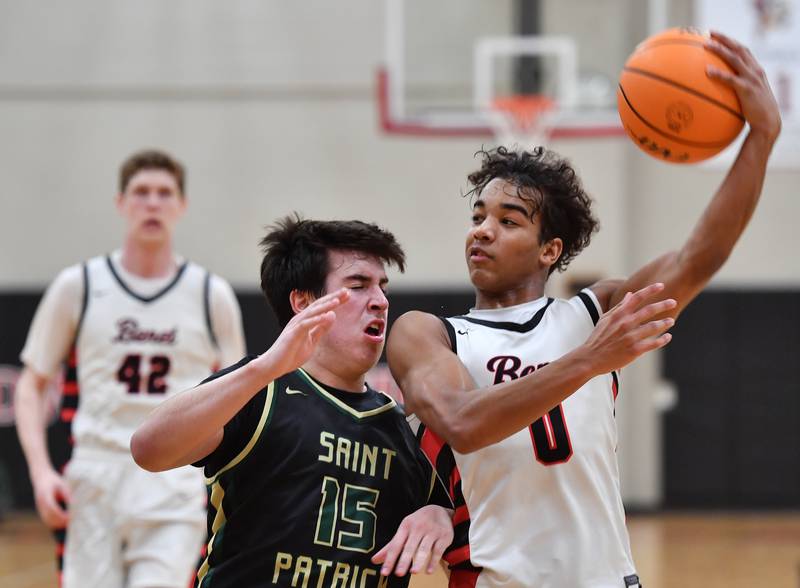 Benet’s Blake Fagbemi slings a pass over St. Patrick’s RJ McPartlin (15) during a game on January 17, 2025 at Benet Academy in Lisle.