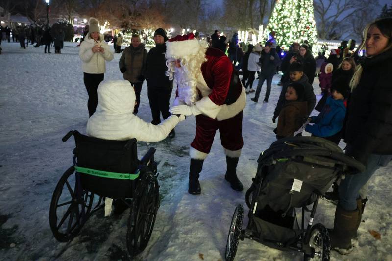 Santa talks with a child at Plainfield’s holiday kickoff Grinchmas on the Green on Saturday, Dec. 5, 2025 in Plainfield.