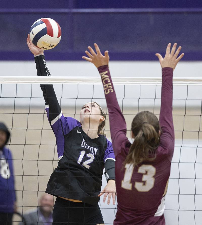 Dixon’s Isabelle Quackboerner spikes against Morris’ Tessa Shannon Thursday, Oct. 31, 2024 in the class 3A regional championship at Dixon High School.