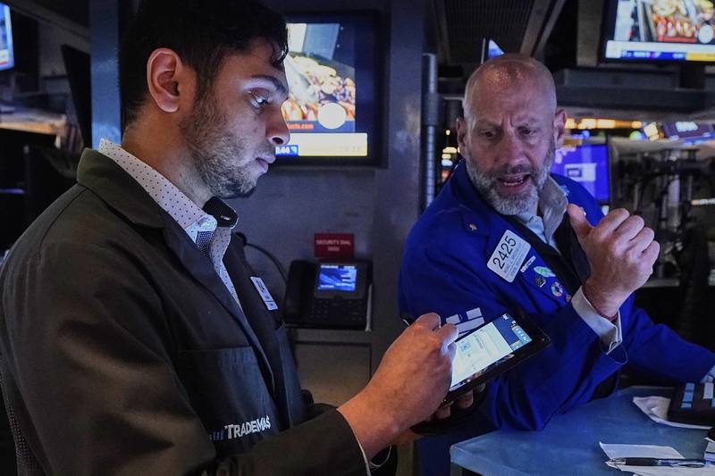 Trader Nial Pawa, left, and specialist Meric Greenbaum work on the floor of the New York Stock Exchange, Tuesday, May 6, 2025. (AP Photo/Richard Drew)