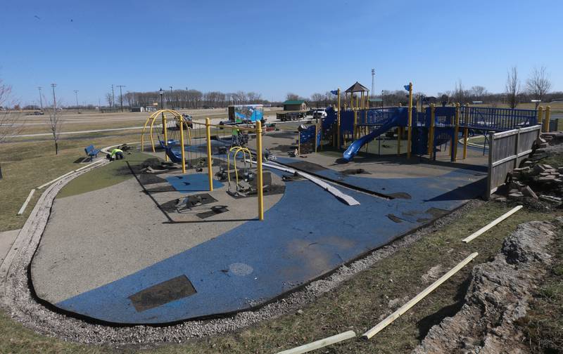 Workers with Team Reil Inc. removes pieces of the surface of the playground at Rotary Park on Monday, March 11, 2024 in La Salle. The playground will be re-surfaced and completed on March 25. The playground will be closed until work is finished.