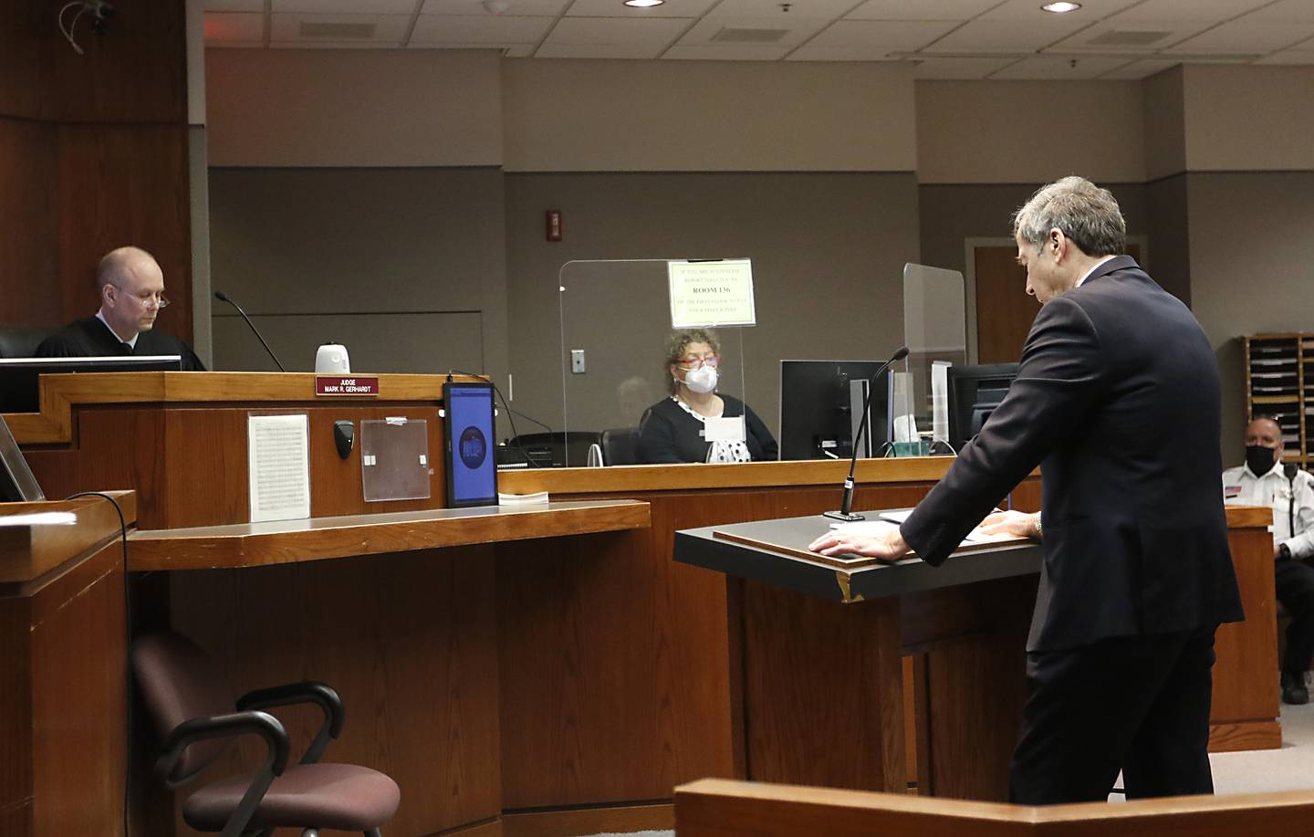 Collin B. Scott, right, through a video conference, listens to court proceedings Friday, Jan 28, 2022, during a motion hearing before Judge Mark Gerhardt at the McHenry County Courthouse. Michael M. Penkava and Scott, both elders in a Crystal Lake Jehovah's Witness congregation, are charged with misdemeanors for failing to report the sexual abuse of a child. Judge Mark Gerhardt listened to a motion on whether a congregant in the church can testify about what she told the two elders or whether that's covered by clergy-penitent privilege and inadmissible.