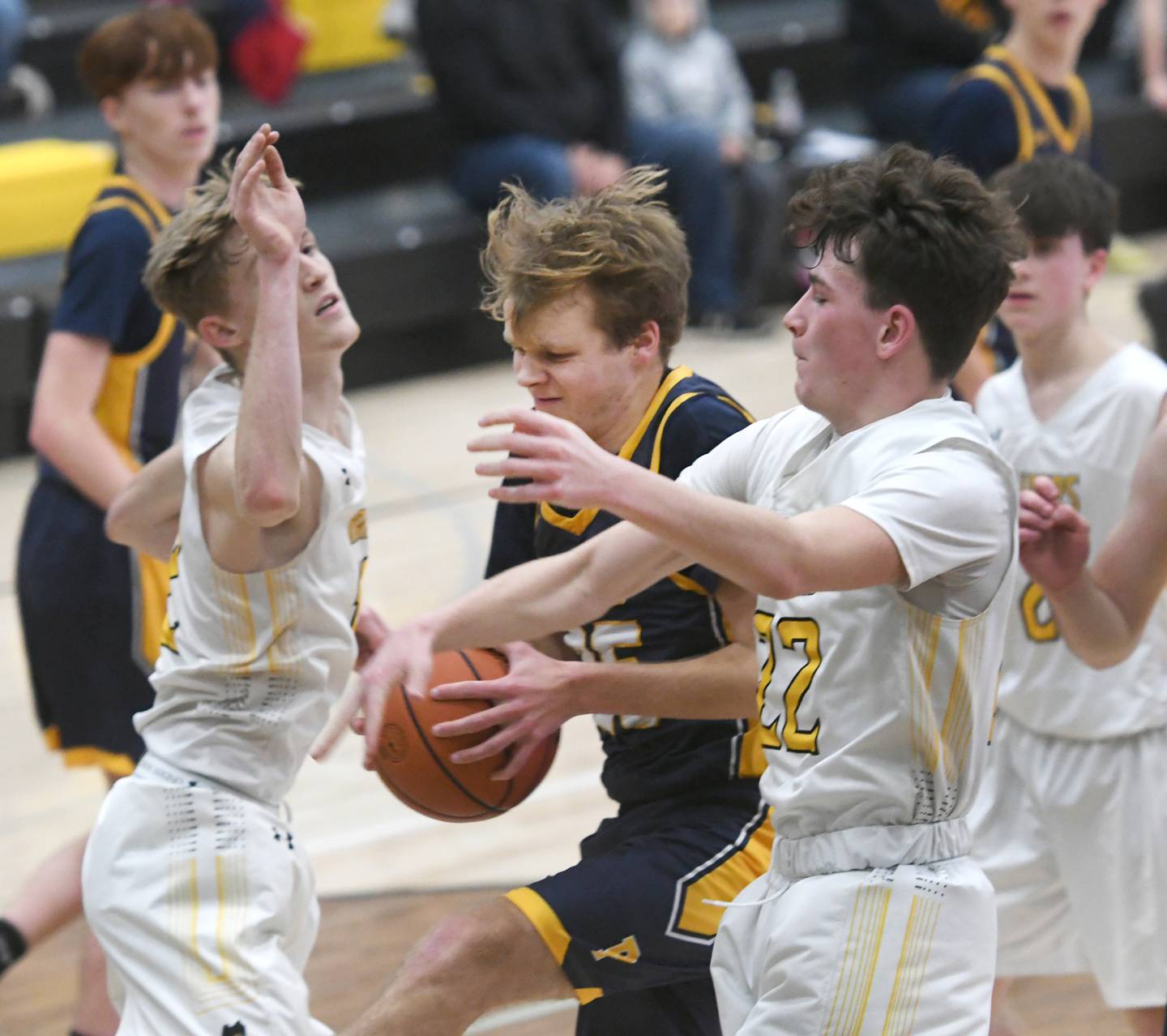 Polo's Carson Jones battles  Ashton-Franklin Center's Lane Koning and Jordan Harris for a rebound during Tuesday night action in Ashton.