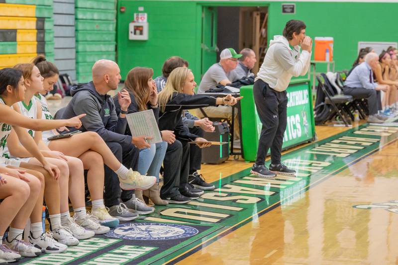 Jenna Maziur (seated, in black), a girls basketball coach at Providence Catholic High School in New Lenox, had an idea for the school to host a basketball camp for students with special needs. Maziur, a former special education teacher, has a 7-year-old son with nonverbal autism who loves basketball. The camp will be held in January 2023.