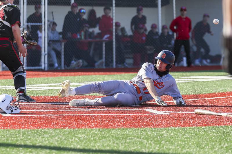 Oswego's Jacob Fehrmann (17) slides home during baseball game between Oswego at Yorkville. Thursday, May 8, 2025 in Yorkville.