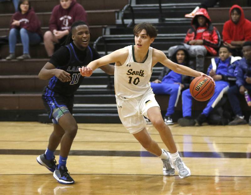 Crystal Lake South's Cam Miller drives to the baseline against Larkin’s Adrian York during a Hinkle Holiday Classic basketball game Wednesday, Dec. 28, 2022, at Jacobs High School in Algonquin.