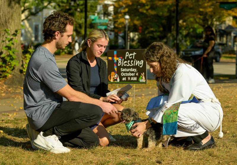 Geneva Lutheran Church’s Pastor Trudy Stoffel blesses “Max” as his pet parents Danny and Gabi Bruski of Geneva look on during the church’s annual pet blessing service on Saturday, Oct 4, 2025 in Geneva.