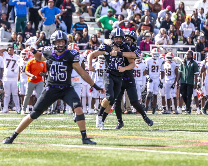 Downers Grove North's Baker Glomb (32) celebrates his field goal to win their football game at Morgan Park Saturday, Aug 30, 2025  in Chicago..