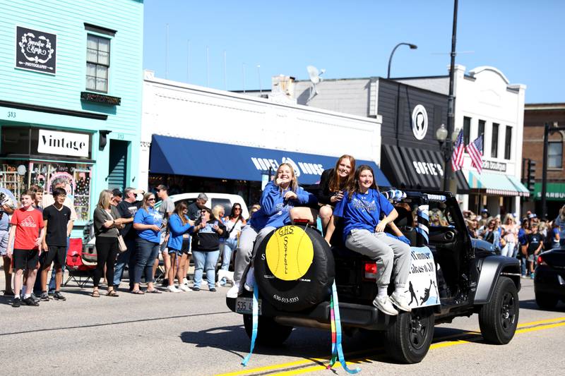 Geneva High School softball players ride in a Jeep during the school’s annual homecoming parade on State Street on Friday, Sept. 15, 2023.