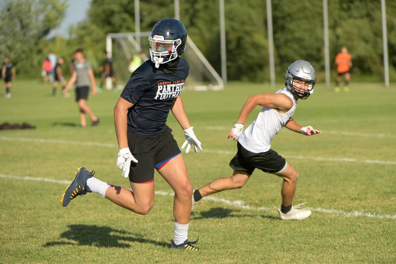 Oswego’s Deakon Tonielli looks for the pass during a 7 on 7 football against Kaneland in Maple Park on Tuesday, July 12, 2022.