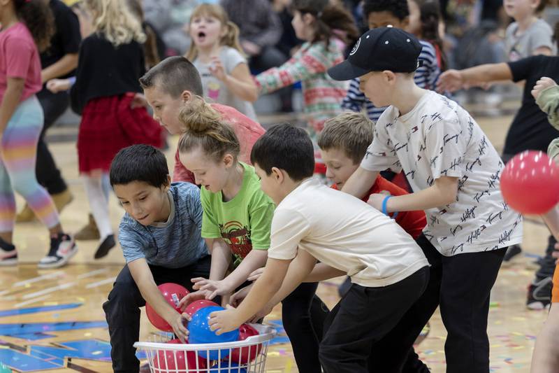 The kids scramble to grab balls at the start of the next contest Saturday, Nov. 18, 2023. 130 kids signed up for the Rock Falls Chamber of Commerce event.