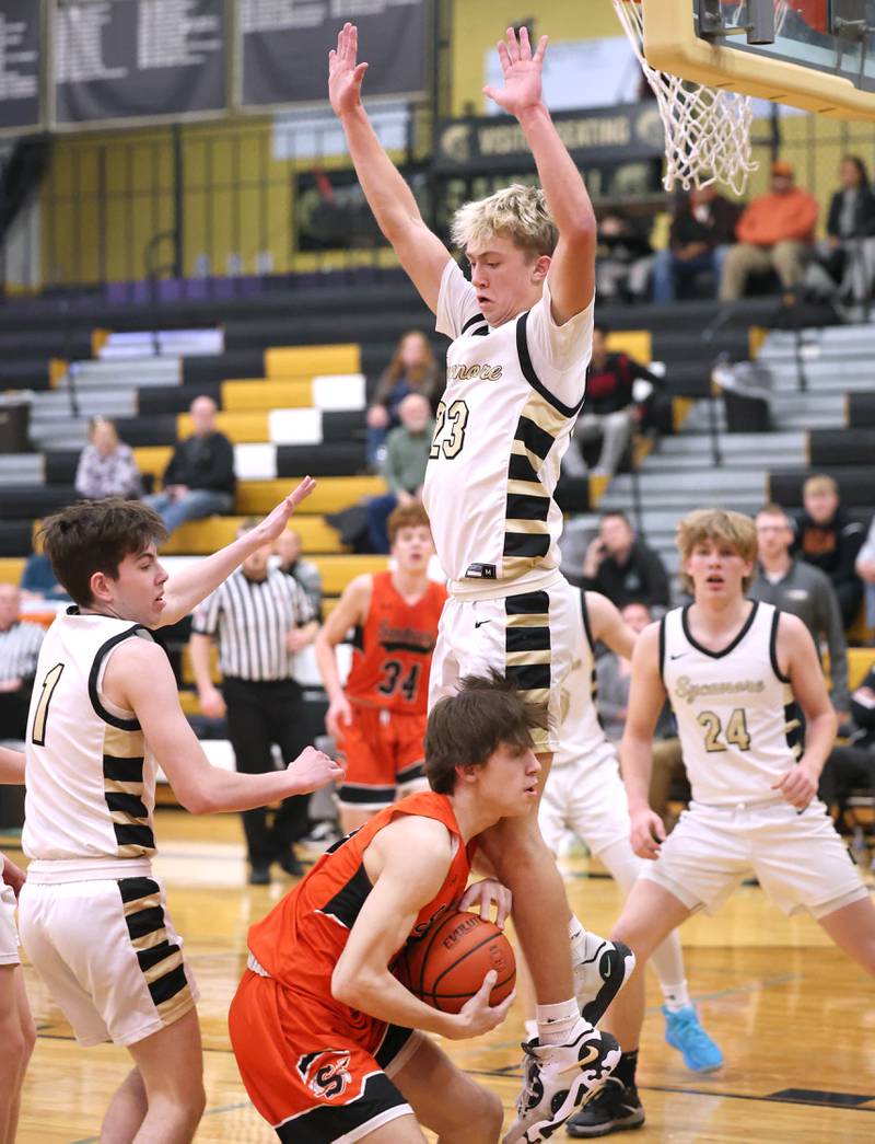 Sycamore's Carter York jumps above Sandwich's Sammy Legget during their game Tuesday, Jan. 17, 2023, at Sycamore High School.