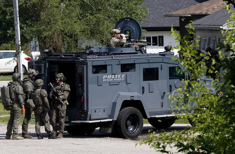 Law enforcement from area departments surround a home on Thursday, June 5, 2025, in the area of Venice Avenue and Court Street in McHenry.