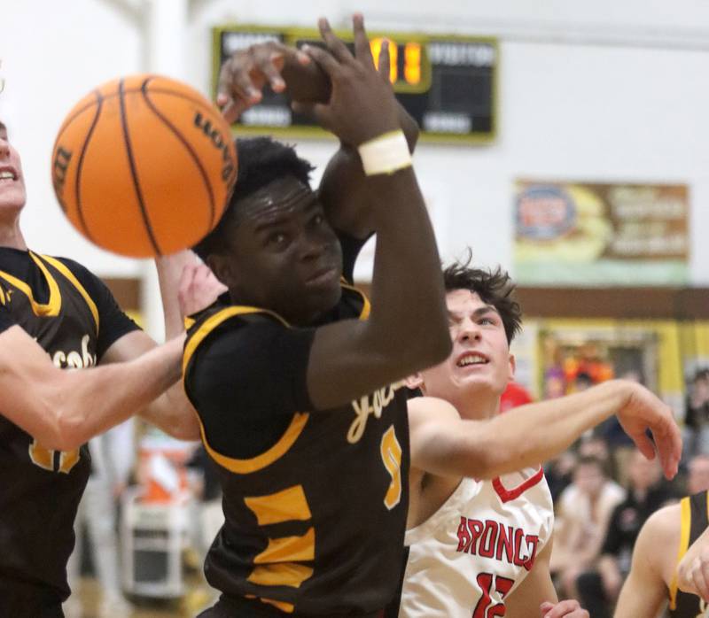 Jacobs’ Samson Averehi, left, battles Barrington’s Ryan Yeh, right, during Hinkle Holiday Classic varsity boys basketball tournament action on Monday, Dec. 23, 2024 at Jacobs High School in Algonquin.