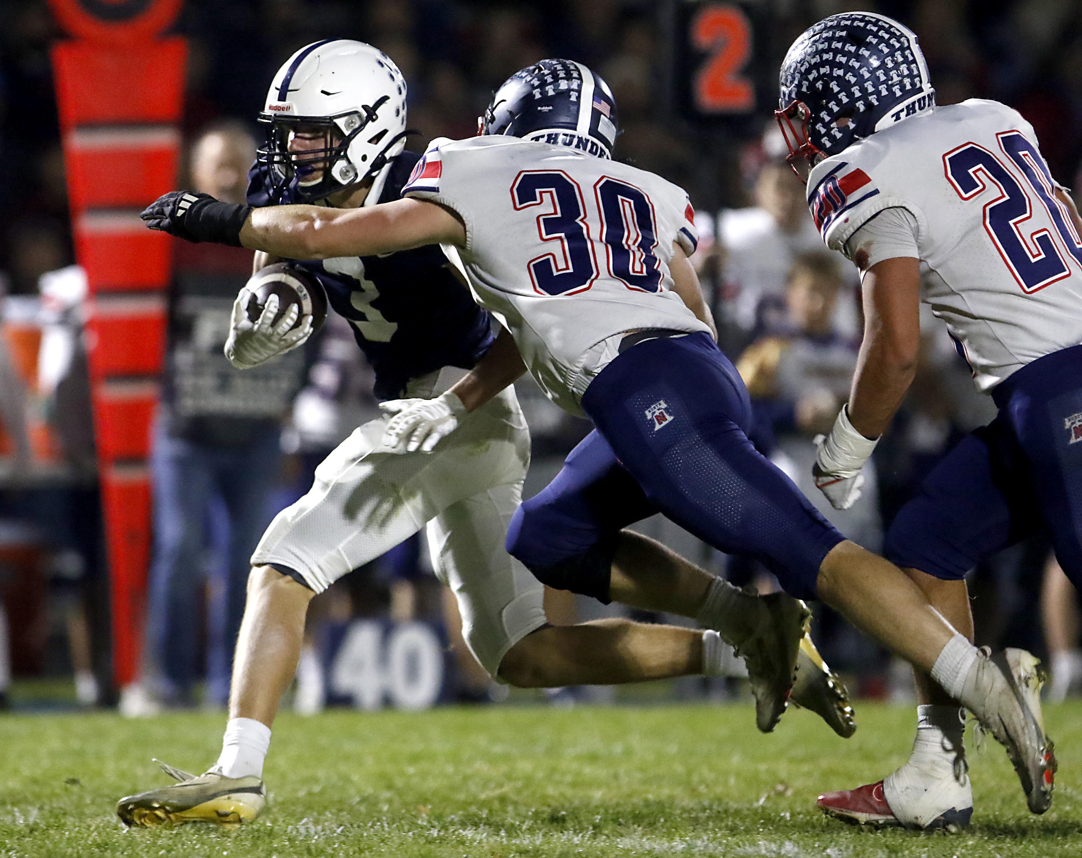 Cary-Grove's Ty Tenopir is tackled by Belvidere North's Dylan Crawford during an IHSA Class 5A quarterfinal playoff football game on Friday, November 14, 2025, at Cary-Grove High School, in Cary.