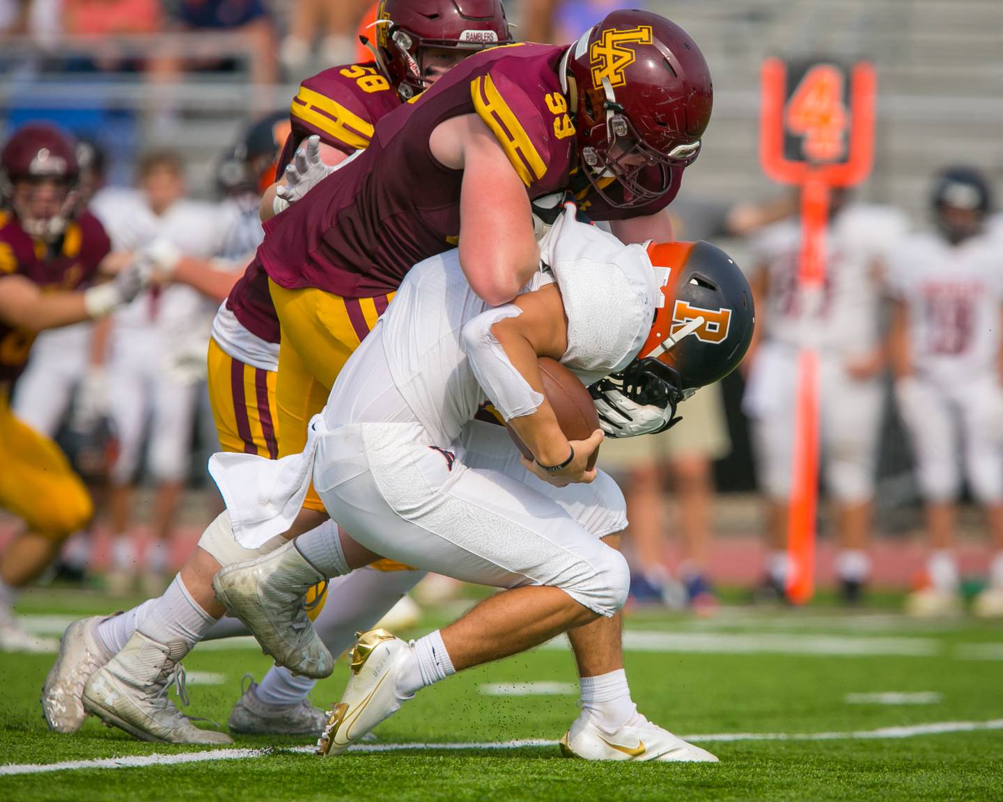 Loyola lineman Brooks Bahr sacks Rochester quarterback Hank Beatty during the second quarter Sept. 4 in Wilmette.