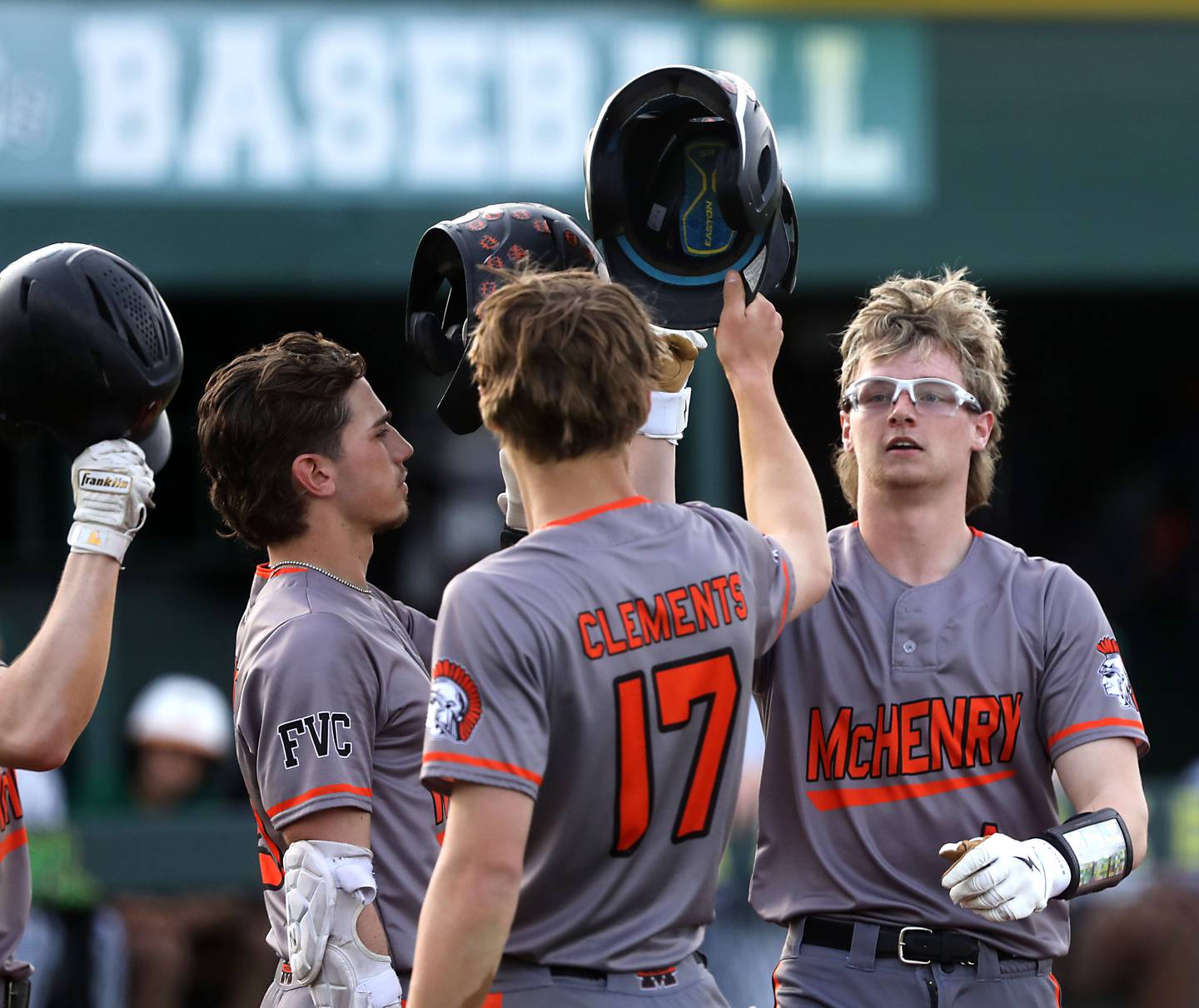 McHenry's Kaden Wasniewski high fives his teammates after he hit a two-run home run during a Fox Valley Conference baseball game against Crystal Lake South on Monday, April 13, 2026, at Crystal Lake South High School.
