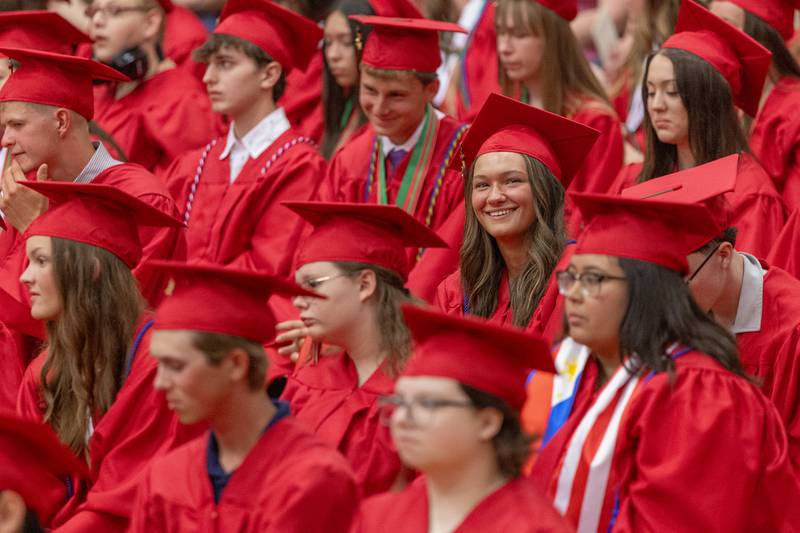 A graduate looks up and smiles at her waving parents in the bleachers at the LaSalle-Peru Township High School Class of 2025 commencement ceremony on Thursday, May 15, 2025 in Sellett Gymnasium.