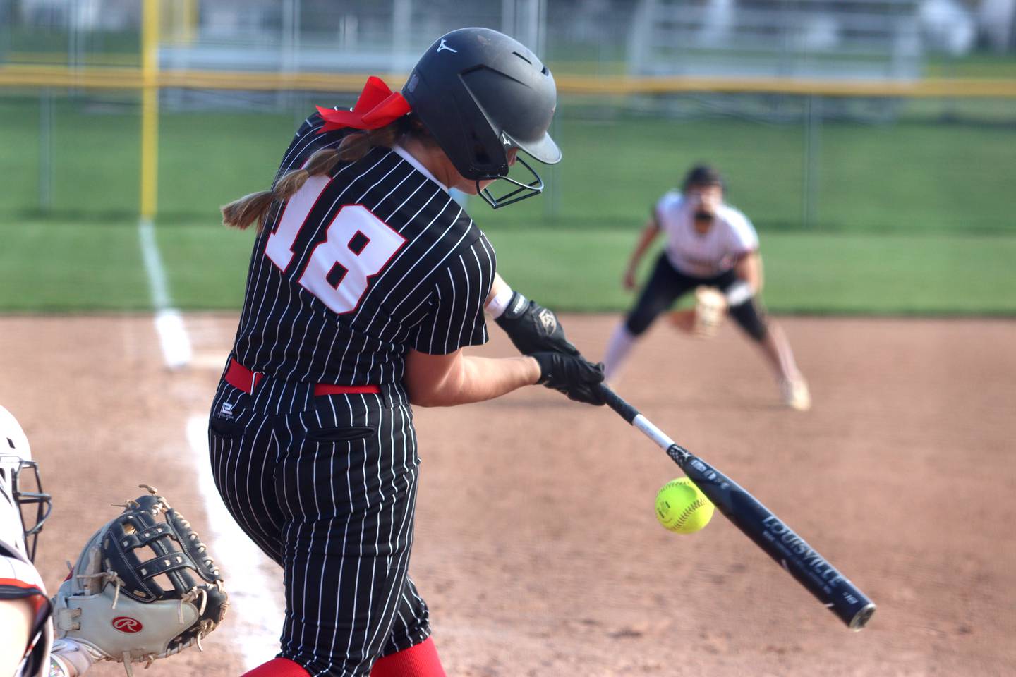 Huntley’s Meghan Ryan makes contact against McHenry in varsity softball at Huntley Friday.