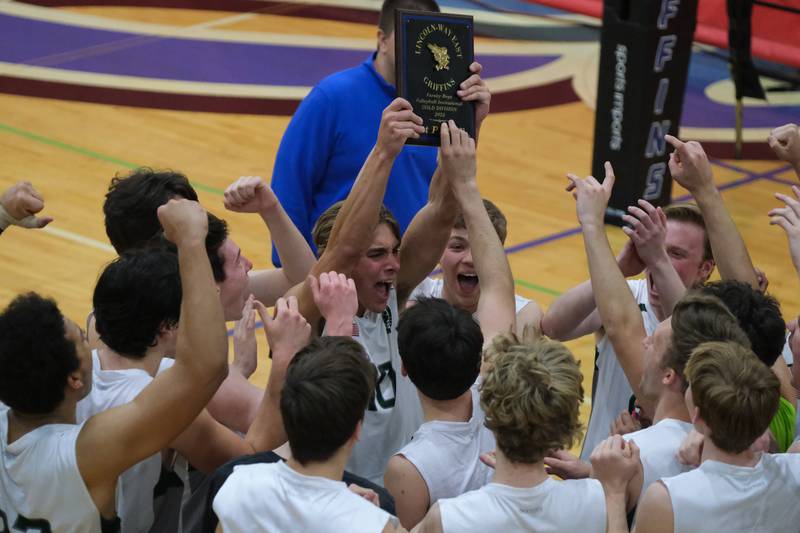 Glenbard West’s Sam Alles holds up the championship plaque after a 2 set win over Roncalli (IN) in the Lincoln-Way East Tournament title match. Saturday, April 30, 2022, in Frankfort.
