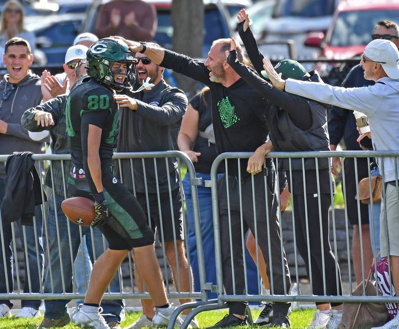 Glenbard West’s Brady Johnson is mobbed by fans after scoring the final touchdown of a game against Joliet Catholic on September 6, 2025 at Glenbard West High School in Glen Ellyn.