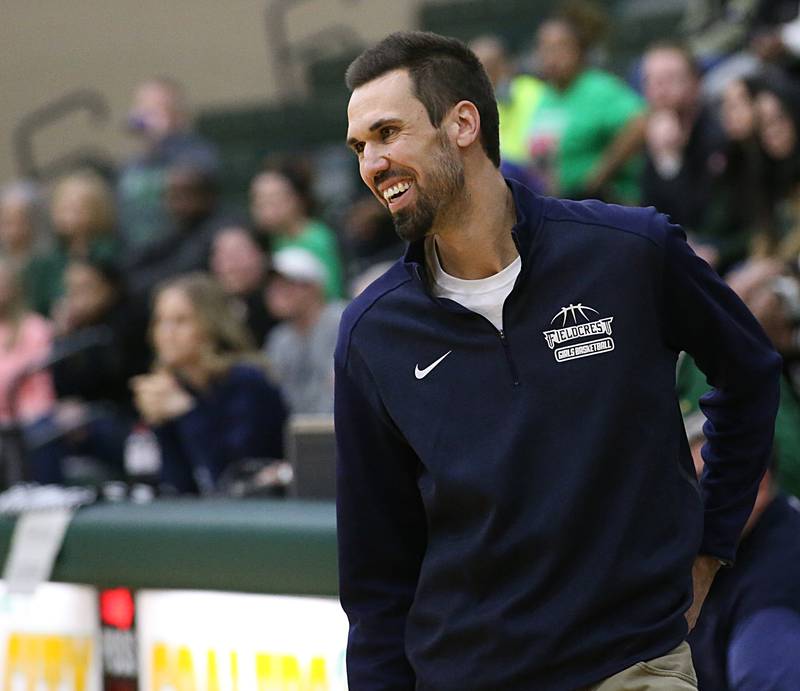 Fieldcrest's head girls basketball coach Mitch Neally smiles as his team defeats Bishop McNamara during the Class 2A Sectional game on Tuesday, Feb. 21, 2023 at Coal City High School.