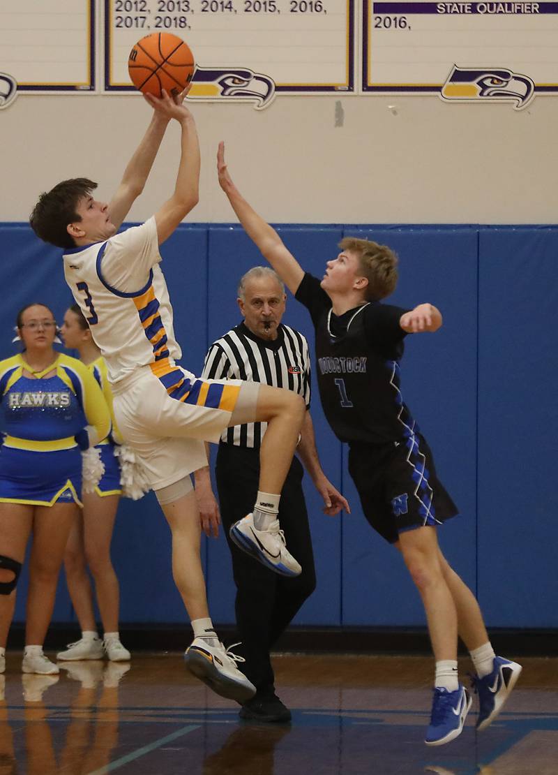 Johnsburg's Trey Toussaint shoots the ball over Woodstock's Rian Hahn Clifton during a Kishwaukee River Conference boys basketball game on Friday, February. 13, 2026, at Johnsburg High School.